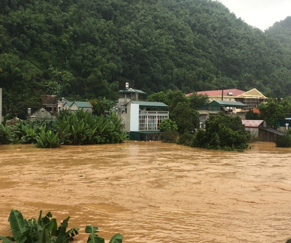Mưa lớn khiến suối Pàn chảy qua thị trấn Hát Lót, huyện Mai Sơn dâng cao gây ngập lụt hàng chục nhà dân. Ảnh: Hà Hoàng